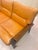 A beautiful vintage sofa from the 1970s with a solid wood frame and removable leather cushions in warm cognac and mustard...