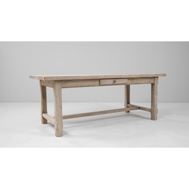 Crafted in France during the 20th century, this oak dining table exemplifies rustic simplicity and functional design. The...