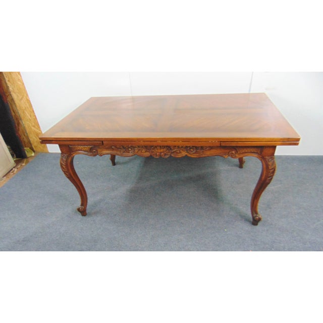 Louis XV style Refectory dining table , made of oak , carved floral accents around skirt and on legs . 2 18" leaves pull...