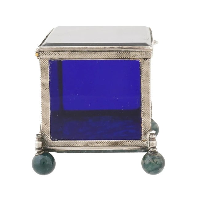 A decorative glass and moss agate box with a 925 sterling silver frame. Two sides of the box feature panels of moss agate,...