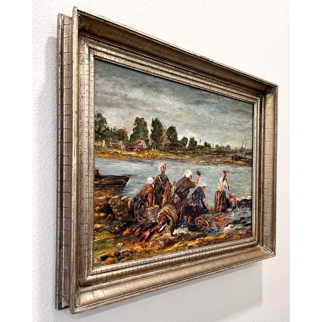 Original impressionist painting of women at the river edge washing clothes. The background landscape is portrayed in muted...