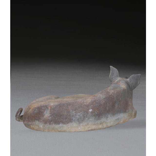 A rare 19th century lead model of a reclining pig, in charming content poise. In good original condition. Dated 1886. h:...