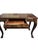 Wooden desk with carved gold leaf foliage details. Curved cabriole legs.
