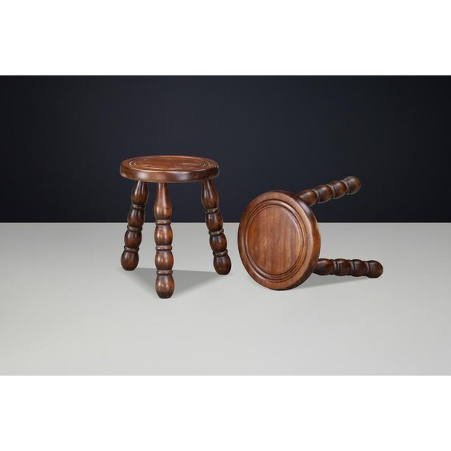 A charming pair of sculptural French stools crafted from solid beech, dating to the 1940s and executed in the distinctive...