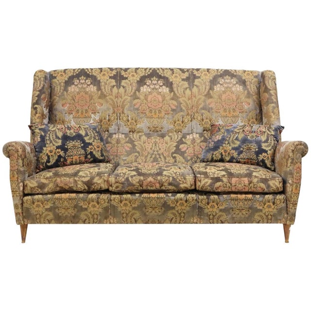 Italian mid-century modern wingback sofa, in the manner of Gio Ponti (Italian, 1891-1979), c.1950s, in button-tufted...