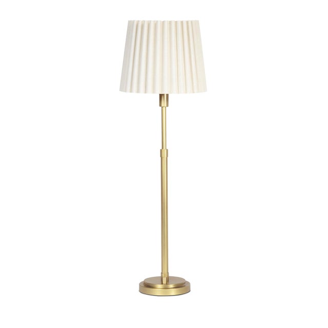 The Polly Buffet Table Lamp showcases sophistication with its single scalloped shade, casting a warm and inviting glow...