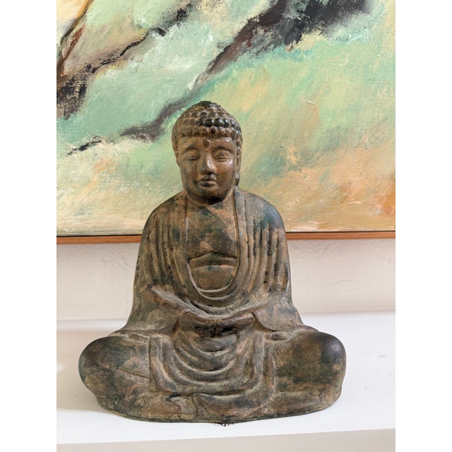 Striking vintage mid-century Japanese cast iron Buddha statue, imported by the Otagiri Mercantile Company (OMC).Crafted in...