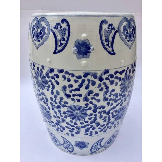 Asian ceramic garden seat or end table in blue and white floral motif. Blue and white Chinese style ceramic garden stool...