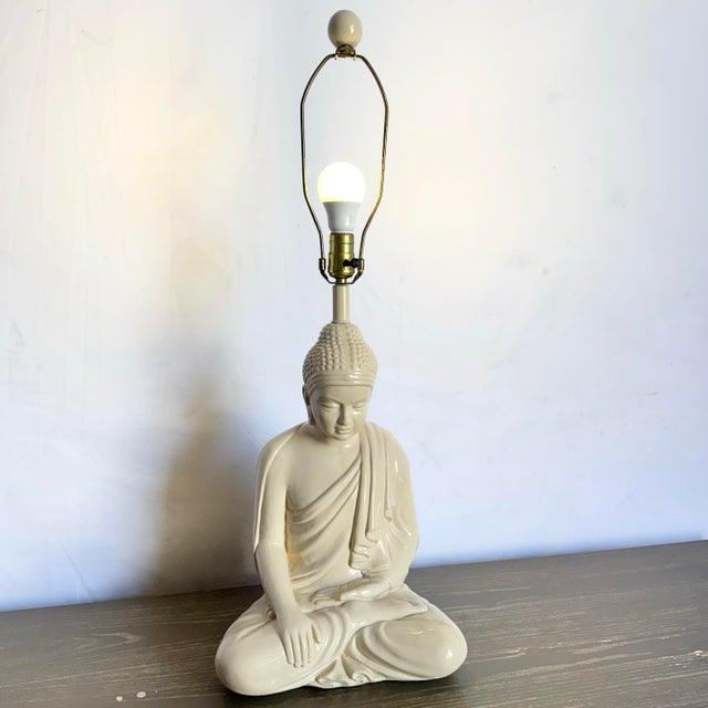 Radiating serenity and vintage charm, this ceramic Buddha sculpture table lamp features a gracefully seated figure with a...