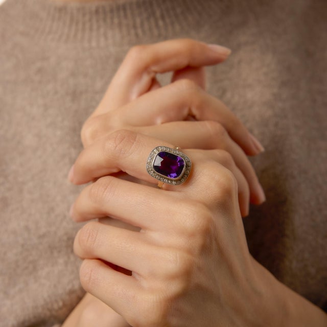 A bold and glamorous jewel of the 1940s, this Retro halo ring centers on a richly saturated 4.35 carat cushion cut...