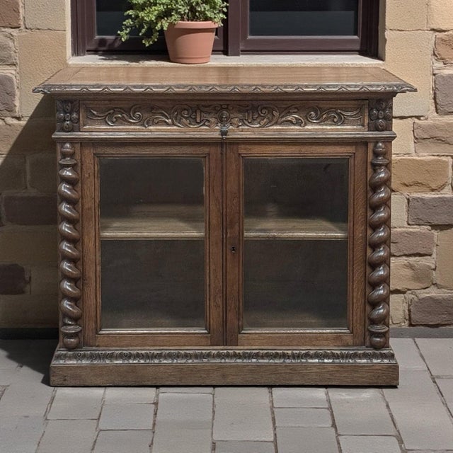 19th Century French Renaissance Revival Oak Vitrine ~ Credenza boasts a beautifully carved façade, barley twist side...
