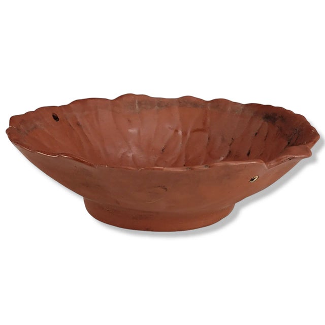This red terracotta planter reflects mid-20th-century utilitarian garden production, formed as a shallow leaf-shape vessel...
