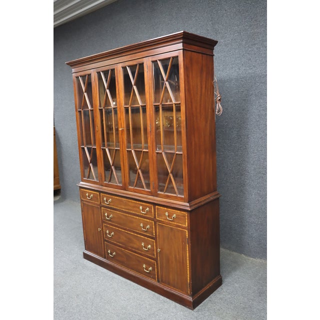 Classic mahogany breakfront china cabinet by Henkel Harris, crafted in a traditional style with clean proportions and...