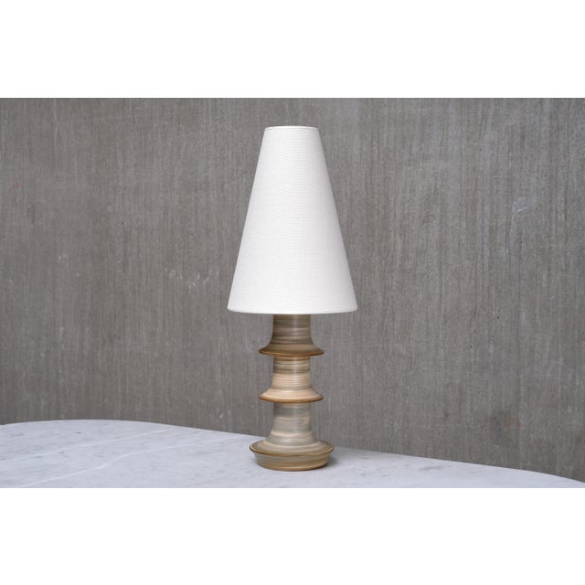 This rare table lamp was produced by Fagerhults Belysning in Sweden in the early 1960s. The stoneware base was...