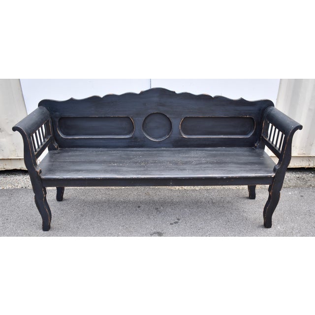 This classic Central European bench form is treated a little differently here. The scalloped back rail ripples gently...