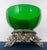 A one-of-a-kind curated vintage centerpiece combining a substantial emerald green art glass bowl with an ornate Hollywood...