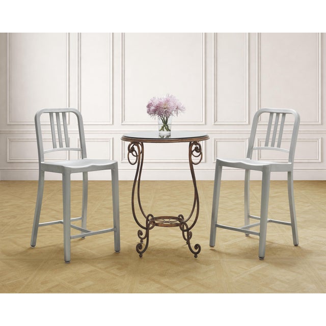 An iconic pair of "Navy" barstools finished in hand-brushed aluminum made by Emeco in the United States. Designed in 1944...