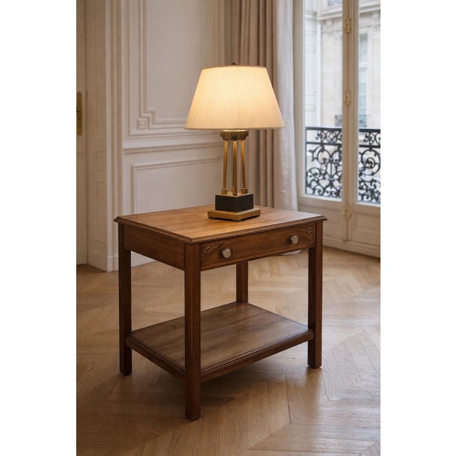 A charming Art Deco side table, dating from the early 20th century, crafted from wood with clean, balanced lines typical...