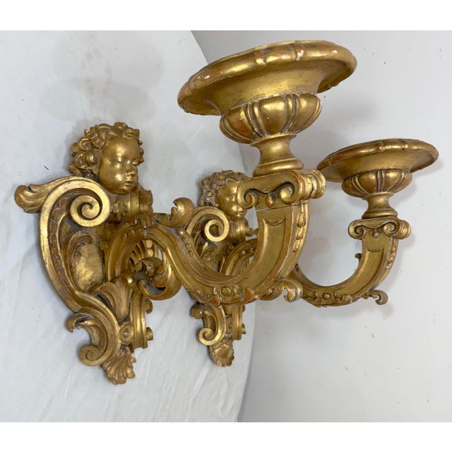 Up for sale is a large pair of antique 19th century Italian gilt-wood figural wall sconces. The sconces are intricately...
