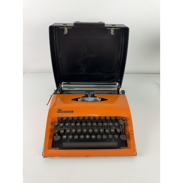 Adler Contessa portable typewriter, 1970 Retro design object known for its bold, bright orange color. Complete and in good...
