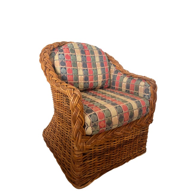 A stunning pair of vintage rattan club chairs with matching ottoman featuring thick braided edging, a honey-toned cane...