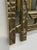 A bold and architectural wall mirror designed by Angelo Brotto, distinguished by its richly textured cast brass frame. The...