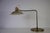 This elegant mid-century brass table lamp from 1960s Germany is a refined example of functional modernist design....