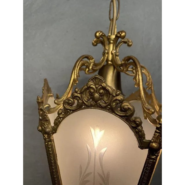 Elegant brass lantern available. Featuring shaped glass panels, twisted arms, and delicate floral detailing, this piece...