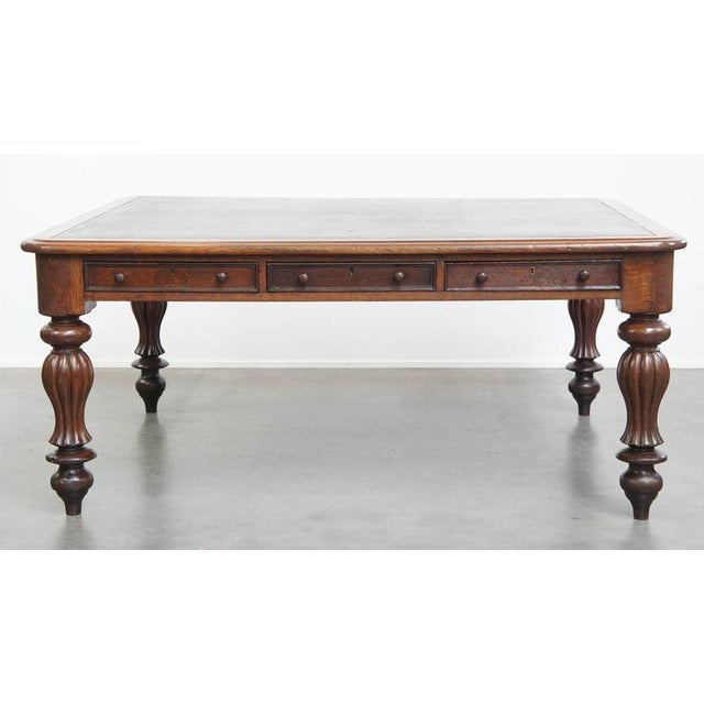Offered this large, unique and antique Victorian English oak writing desk / library table / partner desk with a leather...