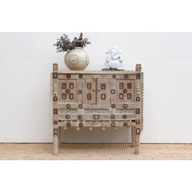 Envision a cabinet born from the heart of India, a piece that once graced a grand home, perhaps a haveli or a royal...