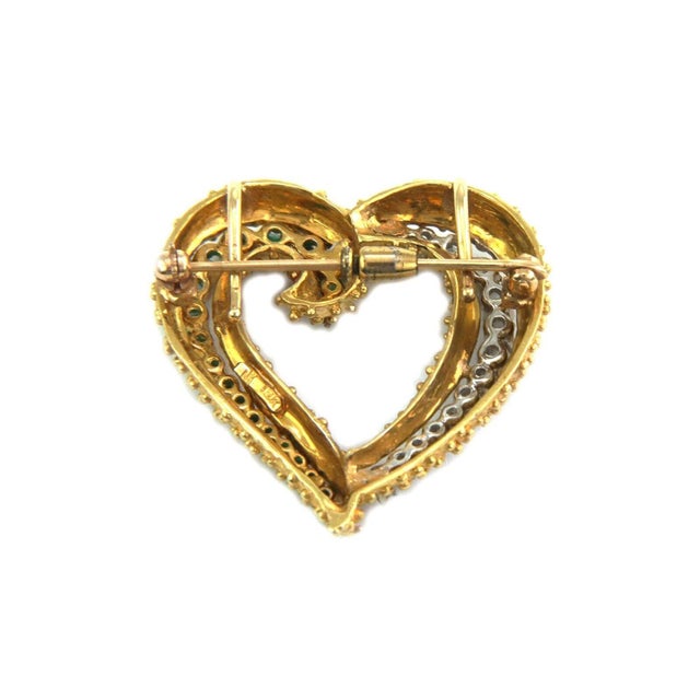 This charming pendant or brooch is crafted from 18k yellow gold with white gold accent featuring an open heart with fine...
