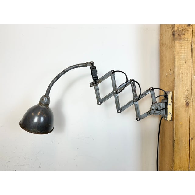 This vintage Industrial grey scissor wall light was produced by Elektroinstala Decín in former Czechoslovakia during the...