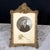 Charming antique French gilt metal tabletop photo frame with an ornate Rococo-inspired crest and finely cast scrolling...