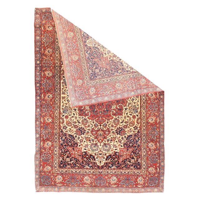 This finely woven central Persian city scatter shows a shaped cream field centred by a flaming complex red cruciform...