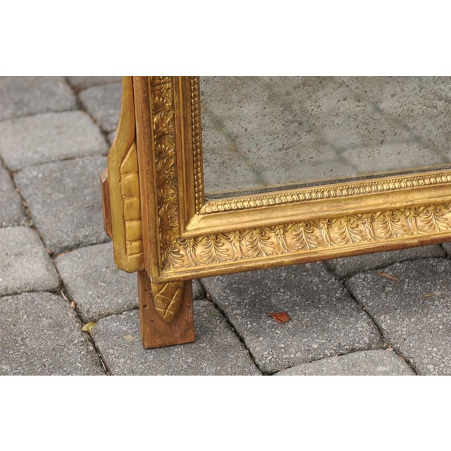 This French carved Louis XVI period late 18th century giltwood mirror features an exquisite pierced and carved crest made...