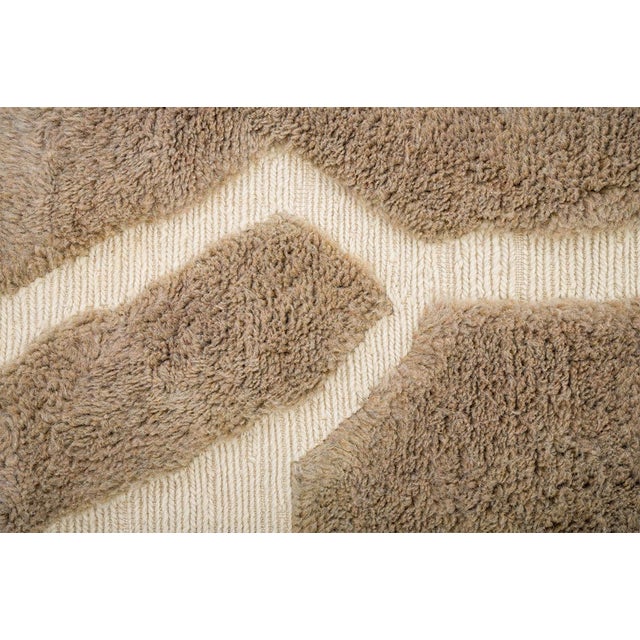 Timeless hand-knotted wool rug in Light Taupe with abstract Ivory linework. The organic, freeform pattern adds a...