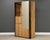 A modern birch color tall dresser armoire with a large door with brass pulls by Founders Furniture. Original finish in...