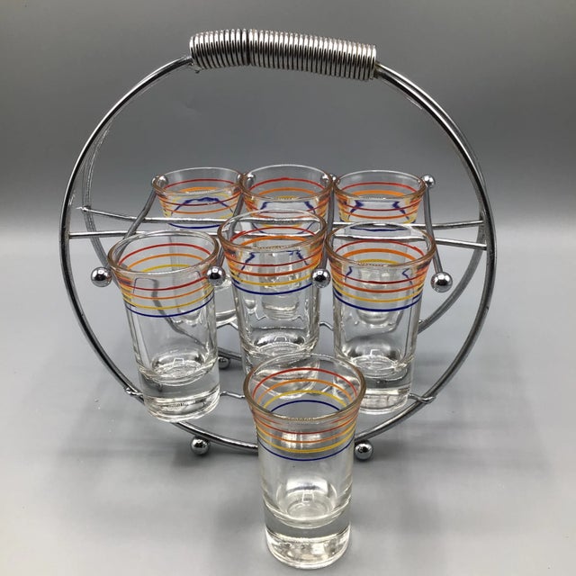 Very cool 6 shot glass chrome plated caddy with spring carrying handle. It comes with 7 (1 extra) 4 color banded Anchor...