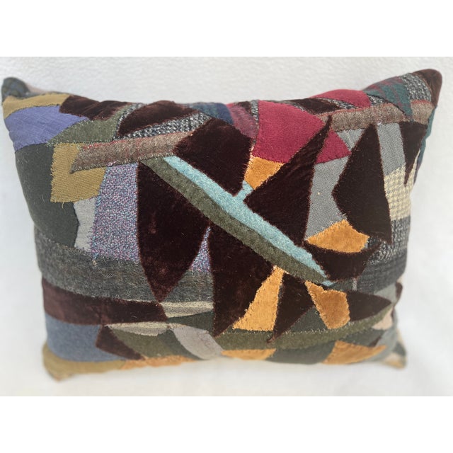This is a pillow upholstered with a patchwork. An artisanal masterpiece for the curated home. The size is 16 X 13 X 5...
