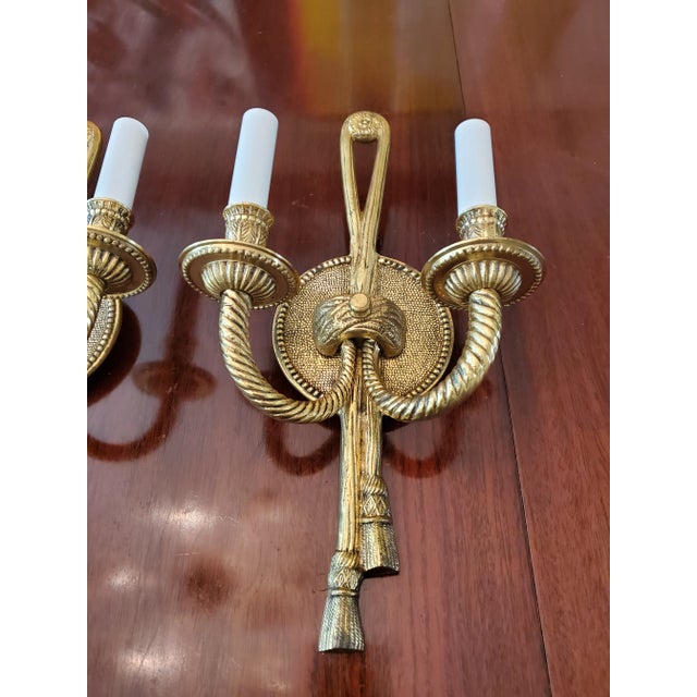 A good pair of 1950's gilt French Louis xv style twisted rope and tassel designed sconces. Fine French workmanship crafted...