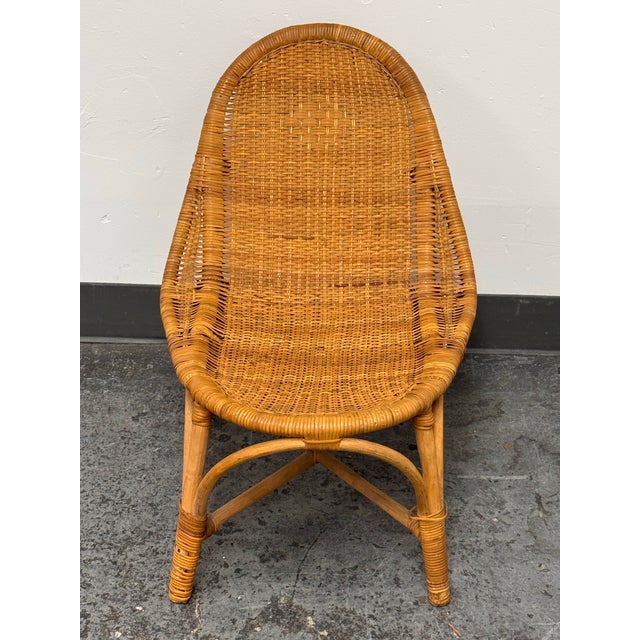 Design Plus Gallery presents a Vintage Rattan Scoop Back Side Chair. The chair has a rounded high back, woven rattan seat,...