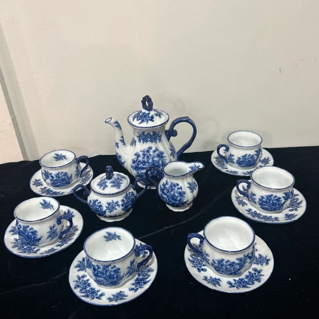 Stunning and rare flow blue teaset. Set includes teapot sugar creamer and 6 cup and saucers. Made of ironstone