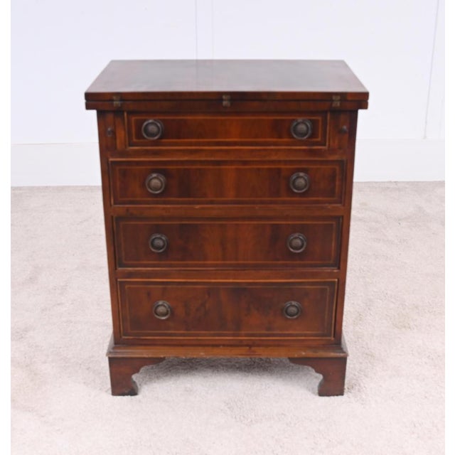 Compact and versatile mahogany bachelorb s chest featuring a practical flip top above a useful arrangement of drawers and...