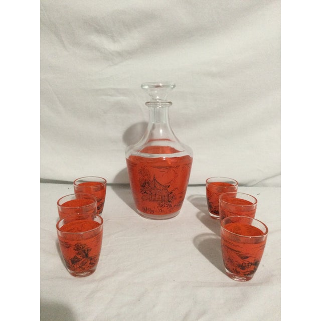 Orange background around the center of the bottle with the outline of an Asian pagoda, incorporating the influence of...