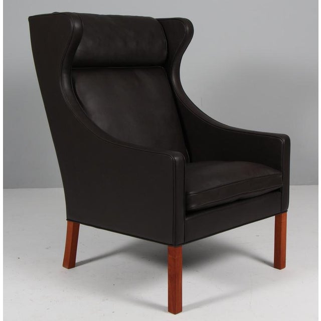 Børge Mogensen wingback chair new upholstered with mokka elegance leather. Legs in teak. Model 2204, made by Fredericia...