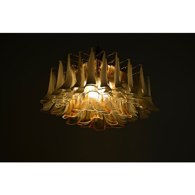 Ceiling light with a brass base and Murano glass petals. Stamped with an M on each petal. Wear consistent with age and...