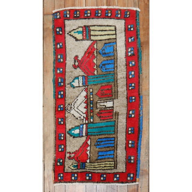 A vintage turkish throw rug depicting a colorful Mosque. Measures: 19" x 36".
