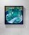 This artwork features three vintage glass bottles resting on a circular surface, their vibrant green hues contrasting with...
