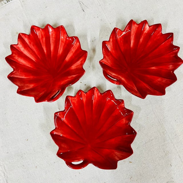 Set of 3 hand painted Fitz and Floyd snack plates in deep red. Each measures approximately 8.5” diameter.