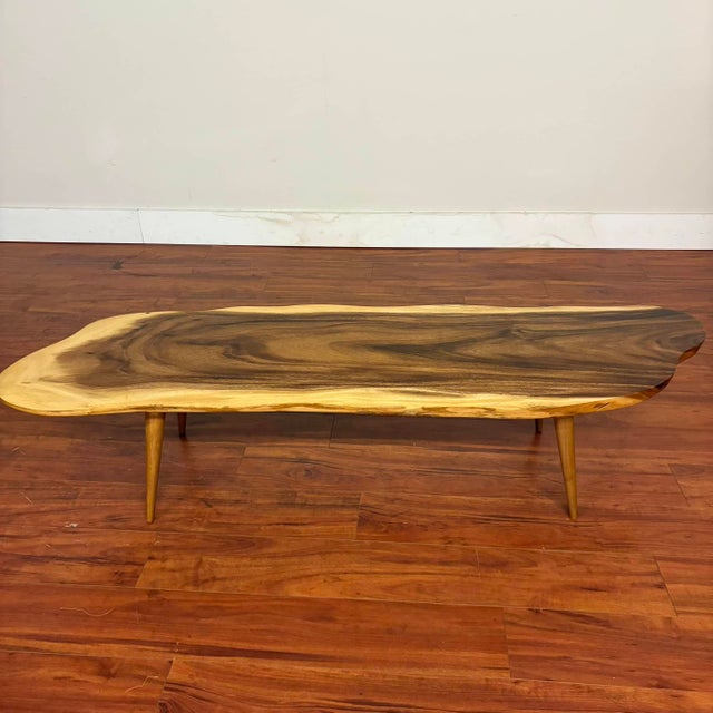 Bring the beauty of nature into your home with this striking freeform live-edge coffee table, crafted from rare and highly...